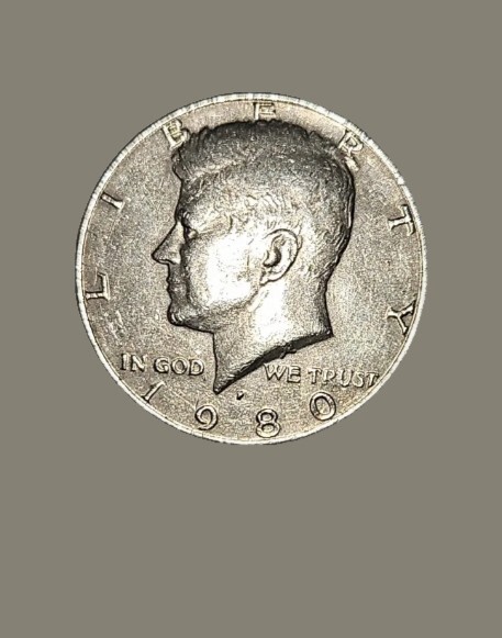 1980 Kennedy half dollar clipped planchet error showing curved missing section at coin edge